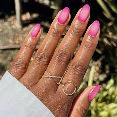 bright pink aura nails closeup