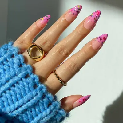 A mani with confetti French tips with a bubblegum pink base