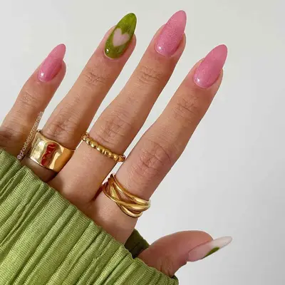 A shimmery bubblegum pink mani with a green accent nail