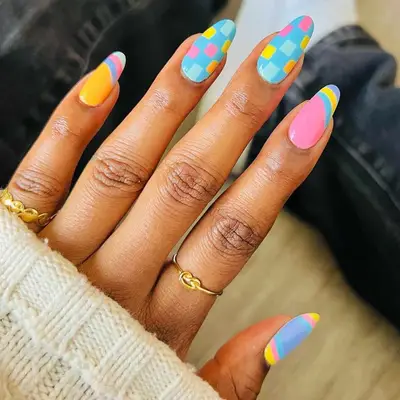 A pastel-colored manicure with a bubblegum pink accent