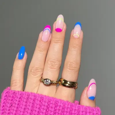 Pink and blue french tips paired with pink and blue half moon and a hint of yellow