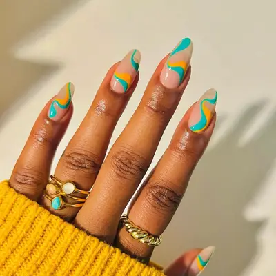 Yellow and blue swirls on almond-shaped nails