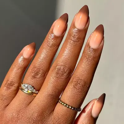 Hand with a brown ombre manicure