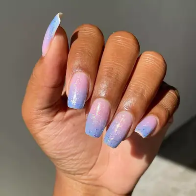 Hand with pink to periwinkle gradient with iridescent glitter