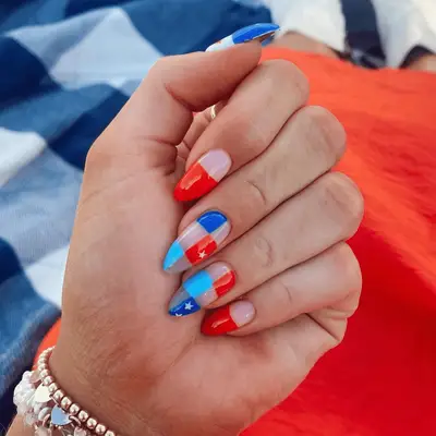 Close up of long nude nails white red and blue checkered print design