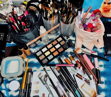 Makeup brushes, products, and tools laid out on table