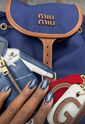 Coco Gauff shows off her blue navy cat eye velvet nails.