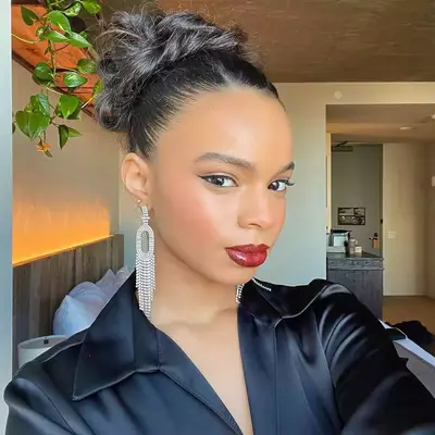 MYM Beauty editor Olivia Hancock wears a radiant makeup look with glossy neutral berry lips