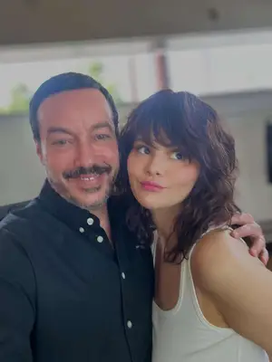 Selena Gomez wearing bangs and posing with Orlando Pita