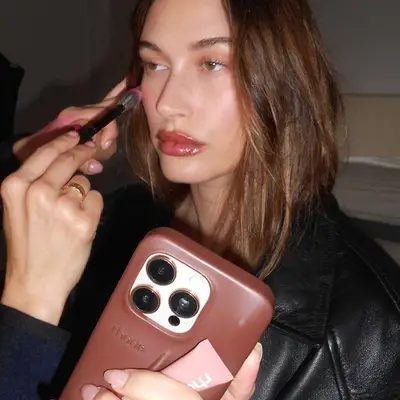 Hailey Bieber getting her makeup done