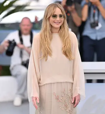 Jennifer Lawrence poses on the Cannes red carpet with her perfect pink nail polish.