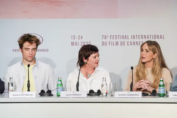 Jennifer Lawrence sits on a panel to show off her perfect pink nail polish.