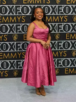 Quinta Brunson wears a pink gown with bow waistline and nude heels to the January 2024 Emmy Awards