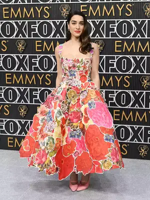 Simona Tabasco wears a patchwork floral gown and pink heels at the January 2024 Emmy Awards