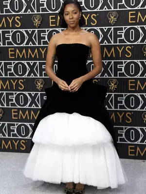 Jessica Williams wears a black-and-white Rodarte gown with tiered tulle skirt to the January 2024 Emmy Awards