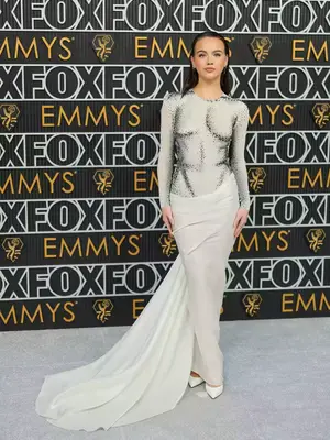 Emma Brooks McAllister wears a white gown with glowing skirt and black anatomical detailing to the 2023 Emmys