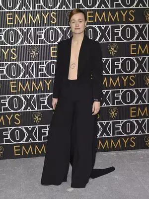 Liv Hewson wears a black suit with wide leg pants and open jacket to the January 2024 Emmy Awards