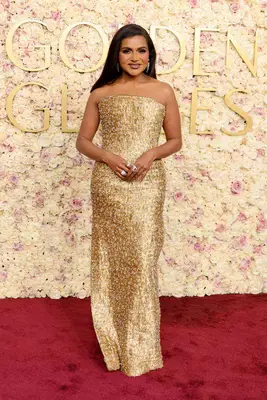 Mindy Kaling in a gold column gown at the 2025 Golden Globe Awards