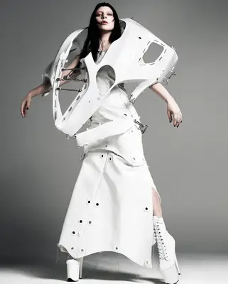 Lady Gaga with black hair in a deconstructed outfit.
