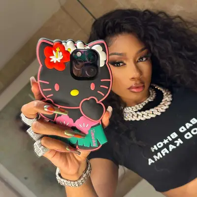 Megan Thee Stallion mirror selfie with multicolor nails with circle designs