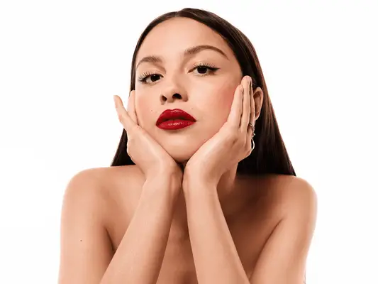 Olivia Rodrigo wearing red lipstick. 