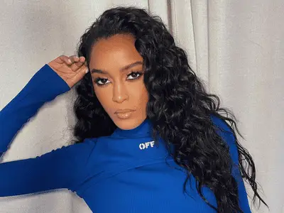 Ciara Miller wearing a blue turtleneck