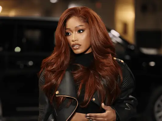 Keke Palmer with red hair and a French manciure