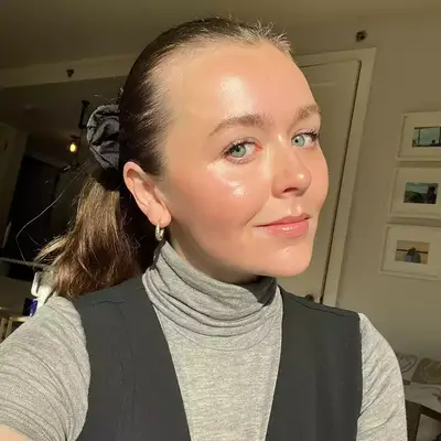woman taking selfie in ponytail in sunlight