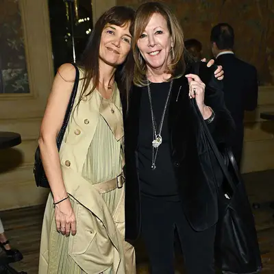 Katie Holmes with brown blunt bangs and a trench-coat dress