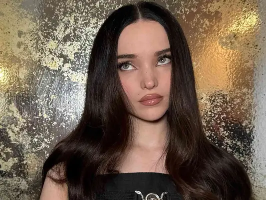 Dove Cameron with a Versace shirt and dark brunette hair