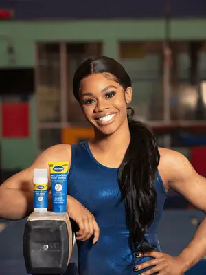 Gabby douglas standing next to Dr. Scholl
