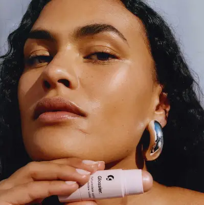 a model with Glossier Futuredew Solid