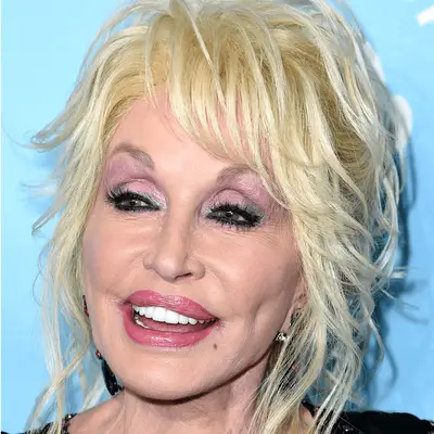 Dolly Parton wears metallic green eyeshadow and coral lipstick