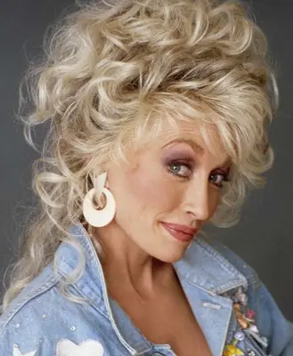 Dolly Parton wears purple eyeshadow and mauve lipstick