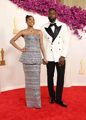 Gabrielle Union-Wade and Dwayne Wade at the 2024 Oscars with coordinating couples manicures and black and white outfitsâa 