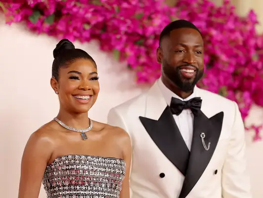 Gabrielle Union-Wade and Dwayne Wade at the 2024 Oscars with coordinating couples manicures and black and white outfitsâa 
