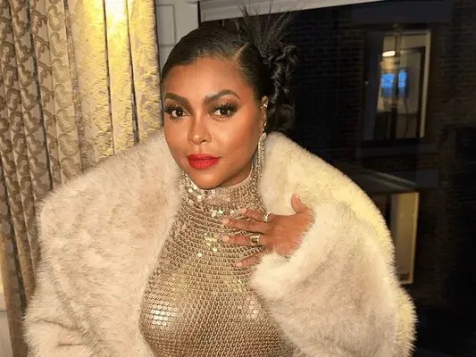 Taraji P. Henson wearing red lipstick and a bun