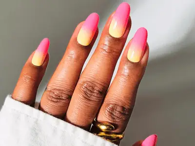 Hand with long nails featuring a gradient design