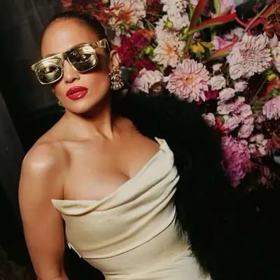 Jennifer lopez in Schiaparelli sunglasses and dress with bold red lips