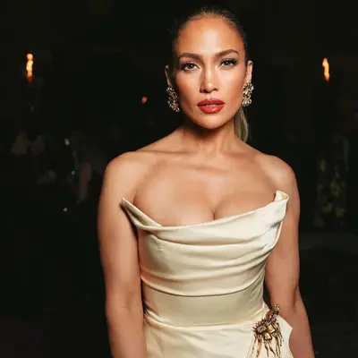 Jennifer lopez in a tan Schiaparelli strapless dress and bold red lips