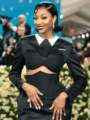Angel Reese wearing flippy bob and black suit-inspired dress
