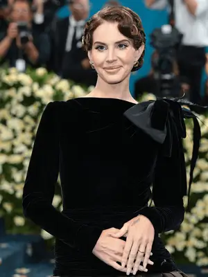Lana Del Rey at the 2025 Met Gala wearing pin curl bun and black gown