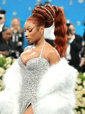 Megan Thee Stallion wearing copper sculptural ponytail