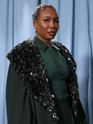 Venus Williams wearing cornrows with silver metallic accents on them and dark lip combo
