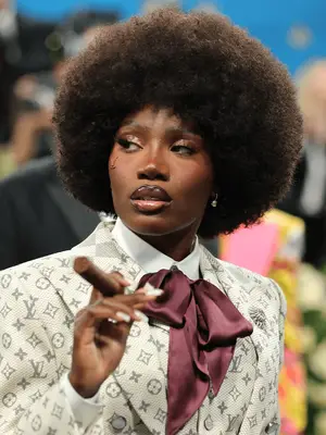 Doechii at the 2025 Met Gala wearing afro and black lip liner with gloss