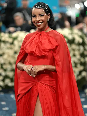 Mona Kosar Abdi wearing a red dress and hair gems at the 2025 Met Gala 