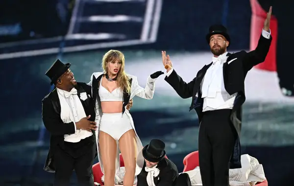 Taylor Swift and Travis Kelce performing at the Eras Tour. 