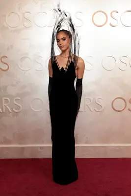 Yasmin Finney wears a black gown with dramatic top from Harris Reed to the 2025 Oscars