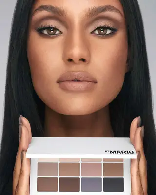 Model holding and wearing the Makeup By Mario Master Mattes: The Neutrals Palette