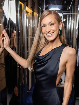 Bella Hadid smiles before walking the red carpet at Cannes Film Festival.